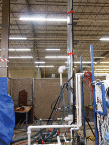 The riser model was scaled down from a 19.5-in. riser to a 6-in. clear PVC pipe with a 2-in. PVC pipe located at the center to circulate mud. The clear PVC allows the fluid level to be monitored and for gas migration and behavior to be observed. A 6-in. clear PVC pipe tee was placed 7 ft from the base to divert the flow from the annulus to a pump in order to simulate the pumped riser section. 